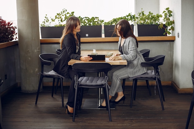Two businesswomen working in a cafe
