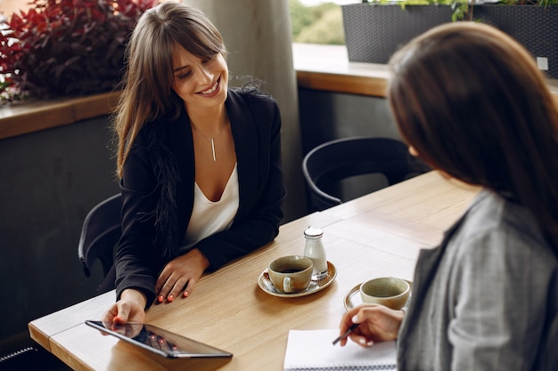 Two businesswomen working in a cafe