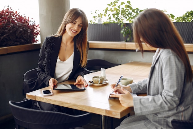 Two businesswomen working in a cafe