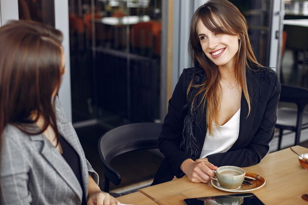 Two businesswomen working in a cafe