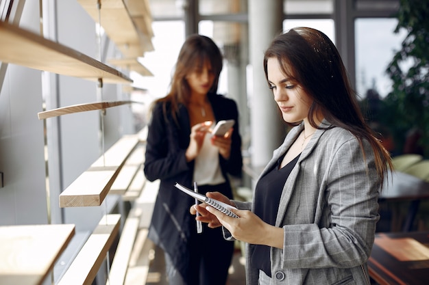 Two businesswomen working in a cafe