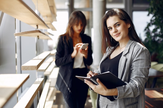 Two businesswomen working in a cafe