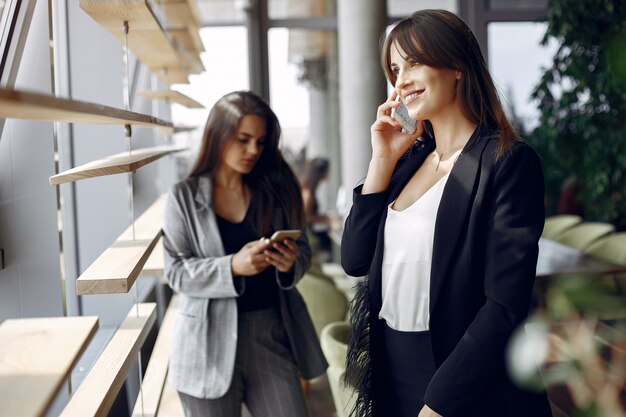 Two businesswomen working in a cafe