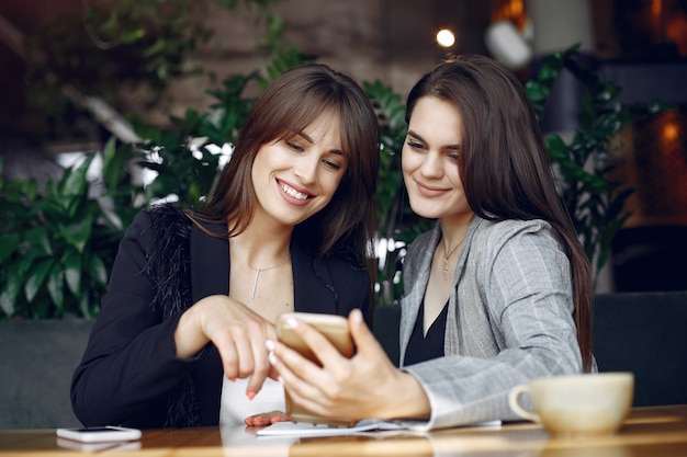 Two businesswomen working in a cafe