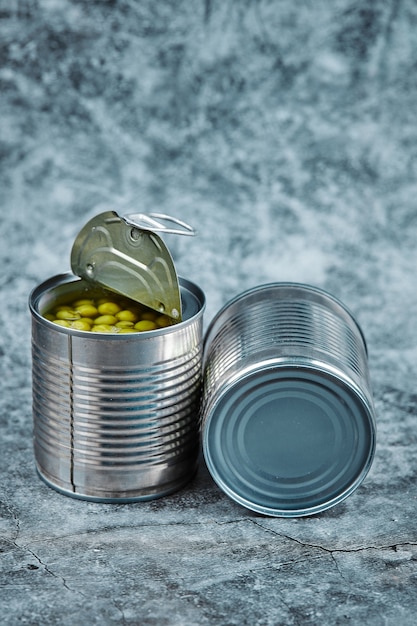 Two cans of boiled green peas.