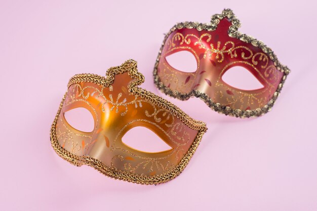 Two carnival masks on table