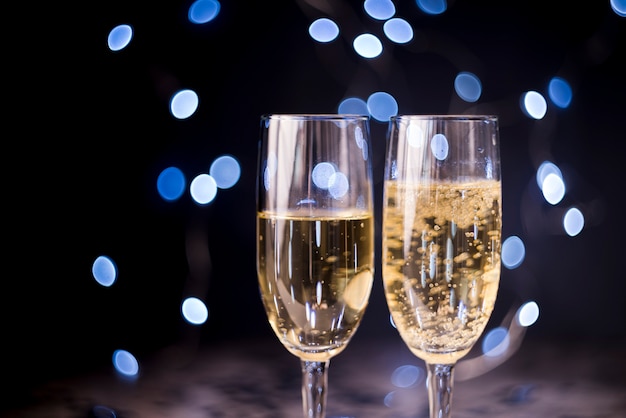 Two champagne glasses on bokeh background