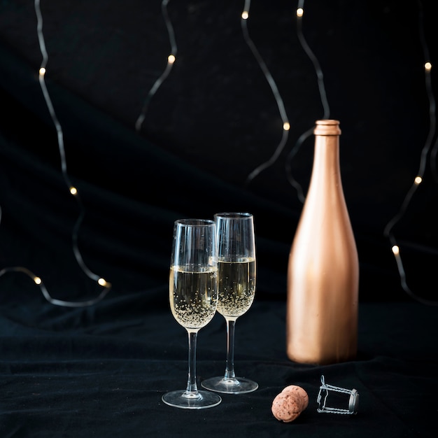 Two champagne glasses on table