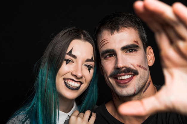 Two cheerful friends with creepy makeup