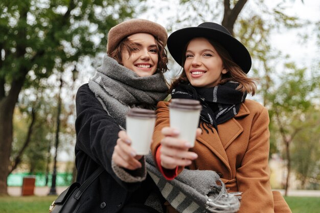 Two cheerful girls dressed in autumn clothes