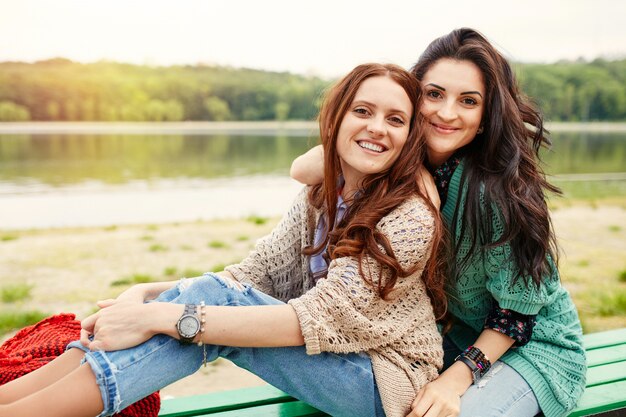 Two cheerful sisters hugging