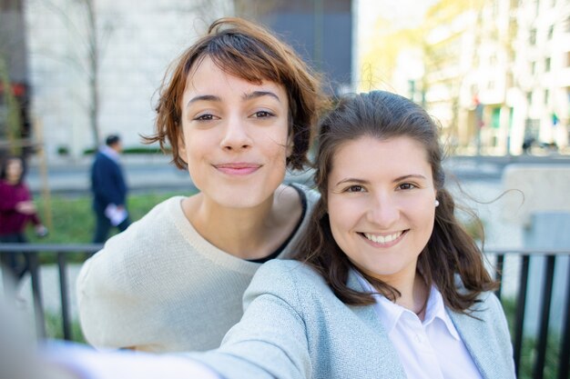 Two cheerful women posing for self portrait