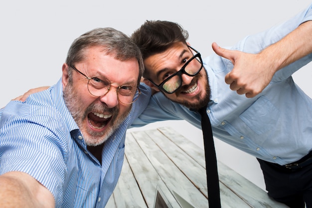 Two colleagues  taking the picture to them self sitting in office