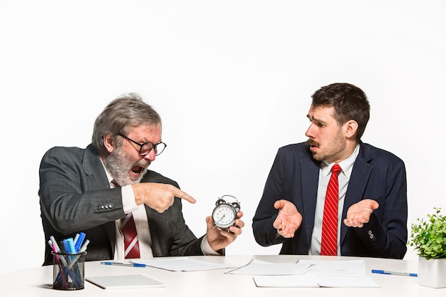 The two colleagues working together at office on white background.