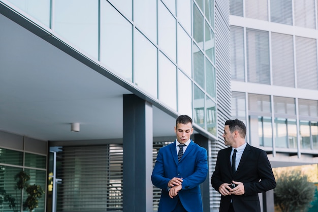 Free photo two corporate businessmen talking