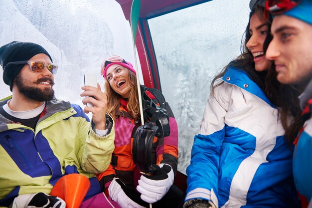 Two couples having fun and snowboarding