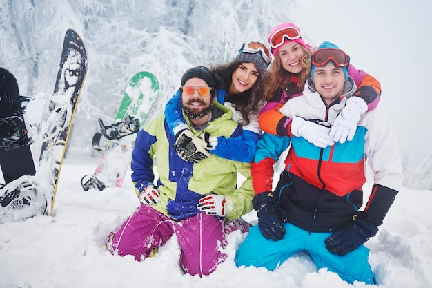 Two couples having fun and snowboarding