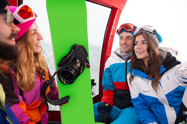 Two couples having fun and snowboarding