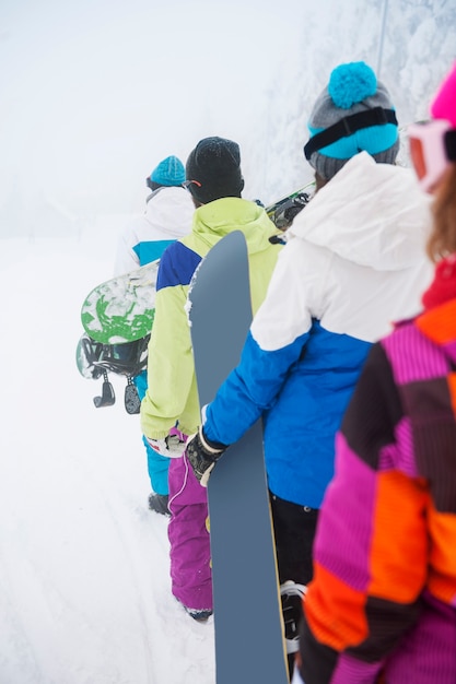 Two couples having fun and snowboarding