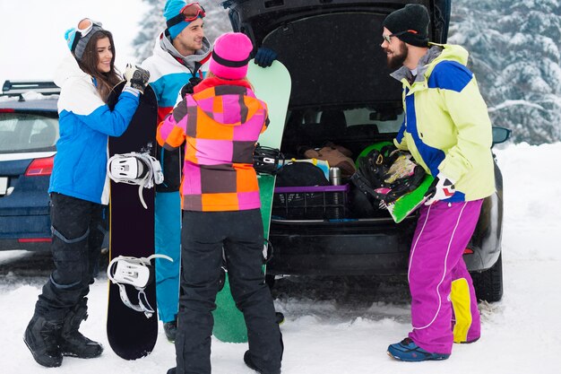 Two couples having fun and snowboarding