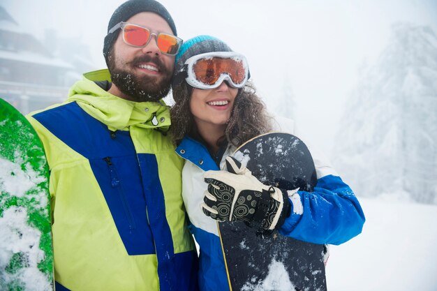 Two couples having fun and snowboarding