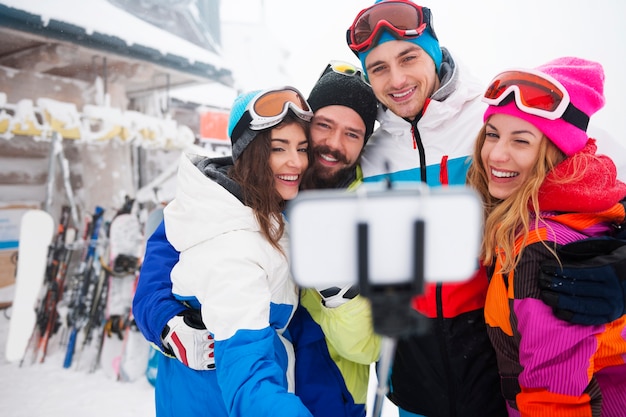 Two couples having fun and snowboarding