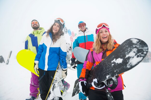 Two couples having fun and snowboarding