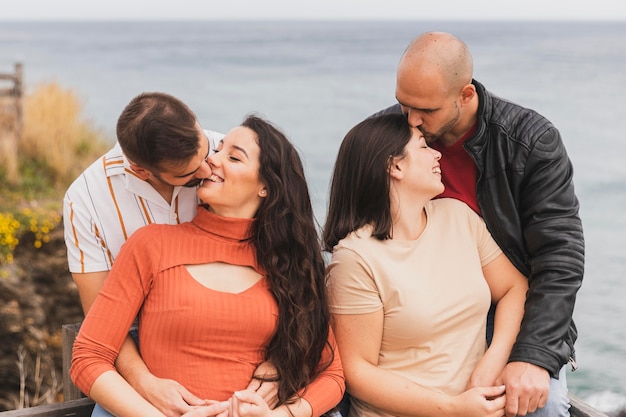 Two couples kissing