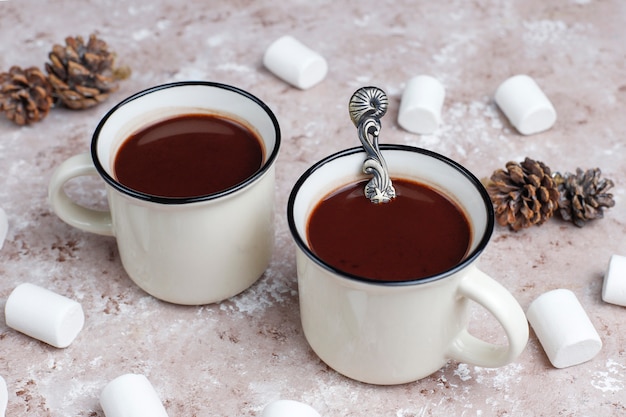 Two cup of hot chocolate with marshmallow on light