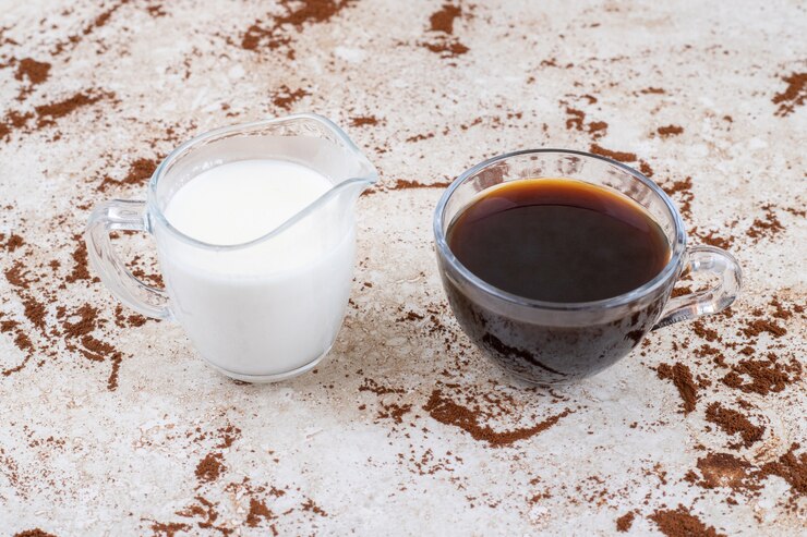 Free Photo two cups of milk and tea on a marble surface