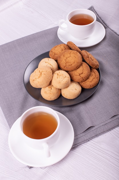 Two cups of tea with biscuits