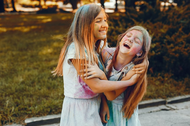 Two cute girls have fun in a summer park