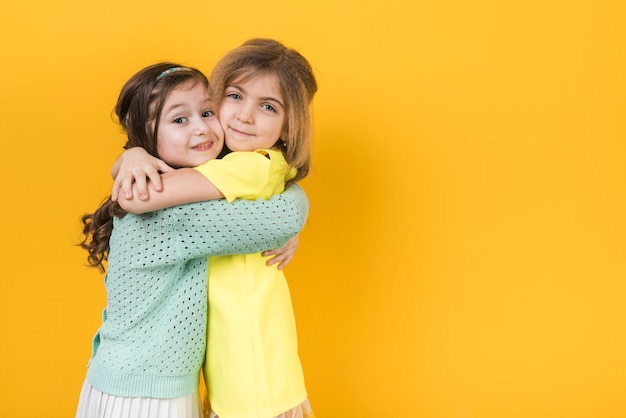 Two cute girls hugging 