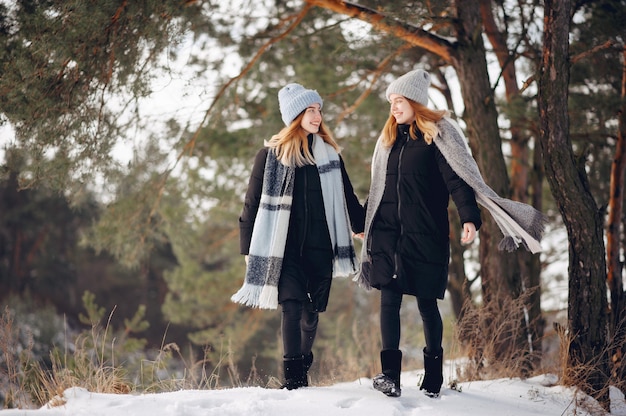 Two cute girls in a winter park