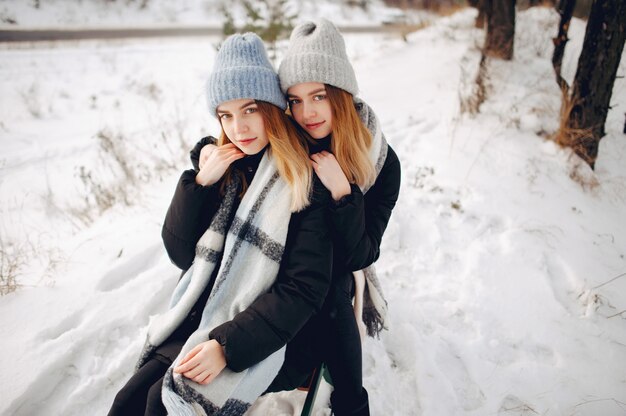 two cute girls in a winter park