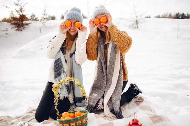 Two cute girls in a winter park