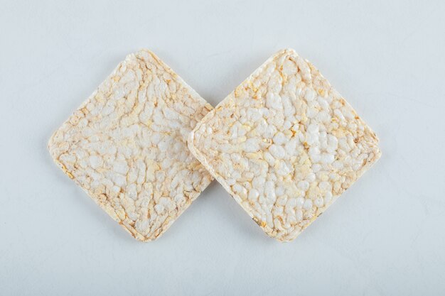 Two delicious airy crispbread on white.