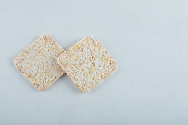 Two delicious airy crispbread on white.