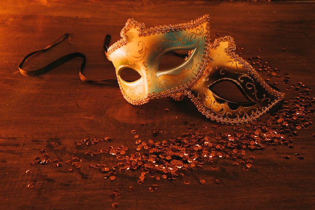 Two different type of elegant venetian mask with sequins on dark backdrop