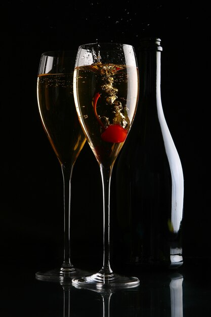 Two elegant glasses with champagne and cherry