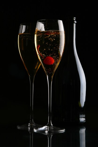 Two elegant glasses with gold champagne