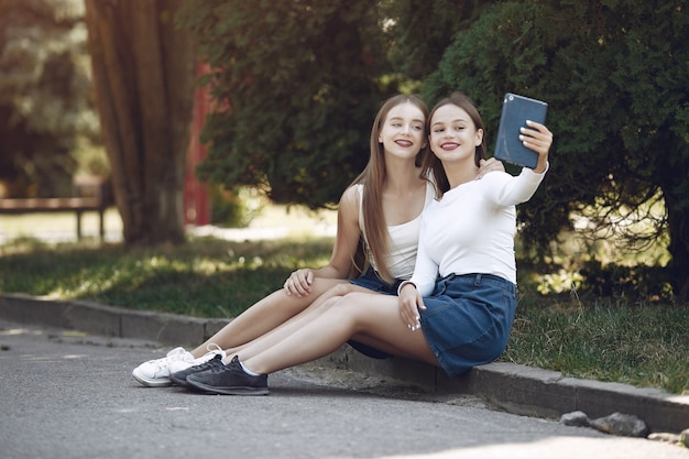 Two elegant and stylish girls in a spring park