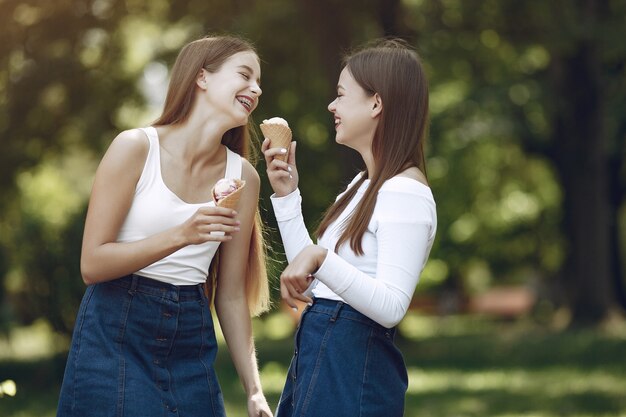 Two elegant and stylish girls in a spring park