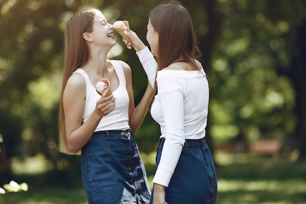 Two elegant and stylish girls in a spring park