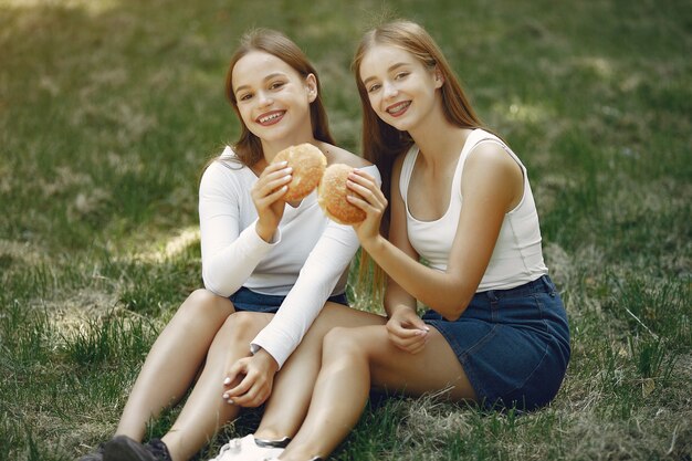 Two elegant and stylish girls in a spring park