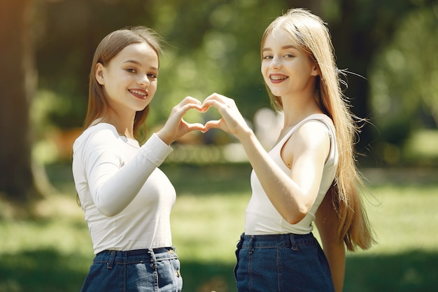 Two elegant and stylish girls in a spring park