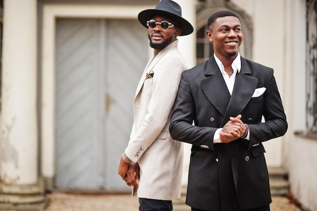 Two fashion black men Fashionable portrait of african american male models Wear suit coat and hat