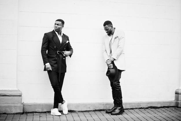 Two fashion black men Fashionable portrait of african american male models Wear suit coat and hat