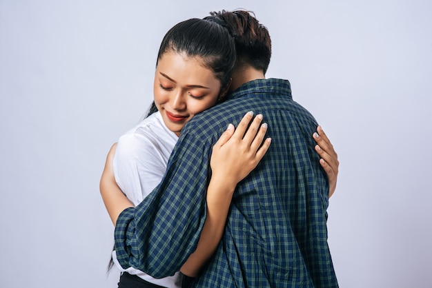 Two female couples standing and hugging each other.