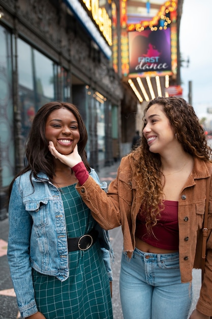 Free photo two female friends having fun while out in the city